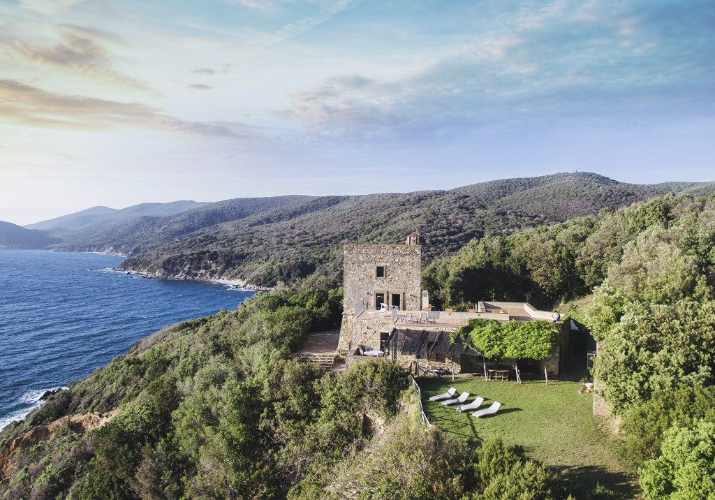 Stone cliffside villa with lawn loungers overlooking the Tyrrhenian Sea
